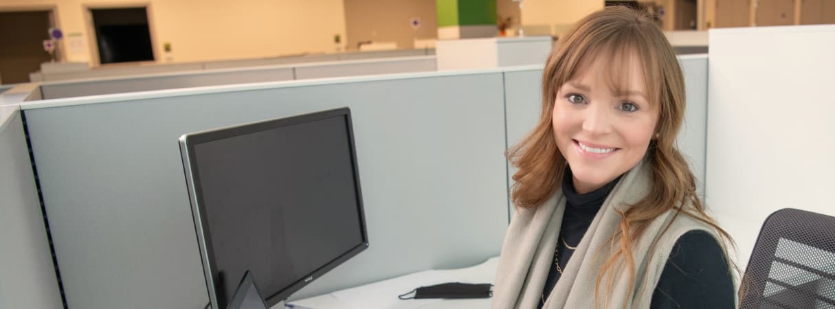 An Image of a woman working on a laptop